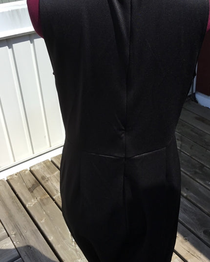 Black 1 pc romper jumpsuit. Low cut open sides