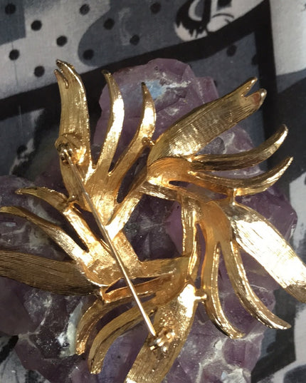 Vintage gold starburst swirl brooch 1960s