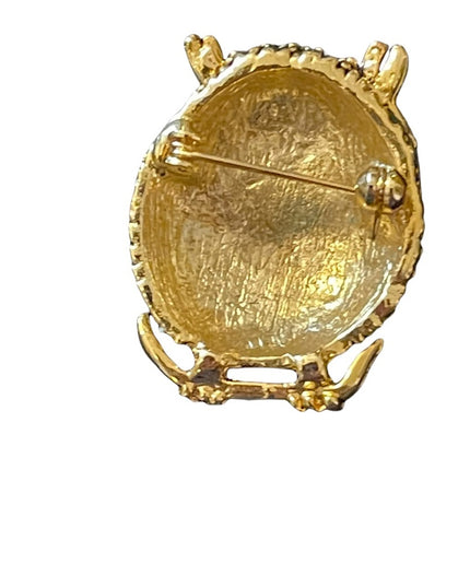 Antiqued gold finish pink crystal eye  brooch