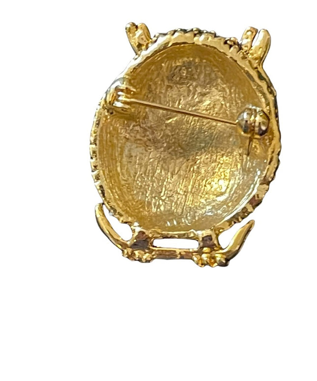 Antiqued gold finish pink crystal eye  brooch