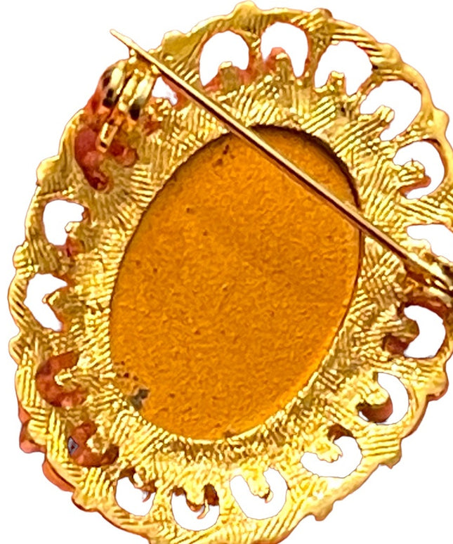 Fancy gold finish resin silhouette cameo brooch