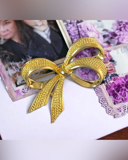 Vintage gold NINA RICCI bow brooch large