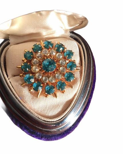 - Vintage blue clear crystal gold starburst brooch