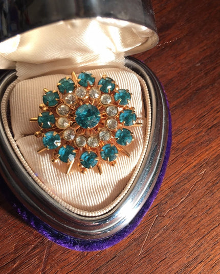 - Vintage blue clear crystal gold starburst brooch