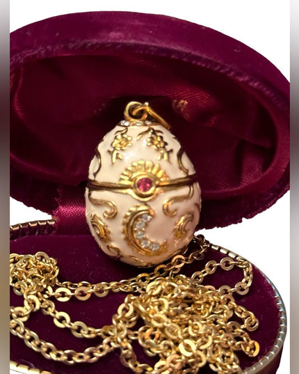 Gold finish creamy enameld crystal embellished Faberge style egg locket necklace