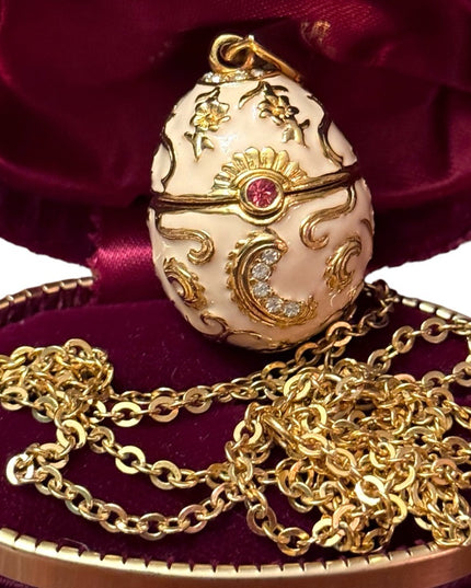 Gold finish creamy enameld crystal embellished Faberge style egg locket necklace