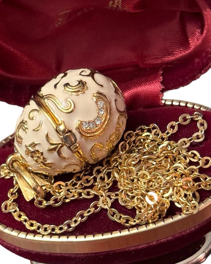 Gold finish creamy enameld crystal embellished Faberge style egg locket necklace