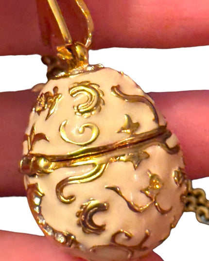 Gold finish creamy enameld crystal embellished Faberge style egg locket necklace