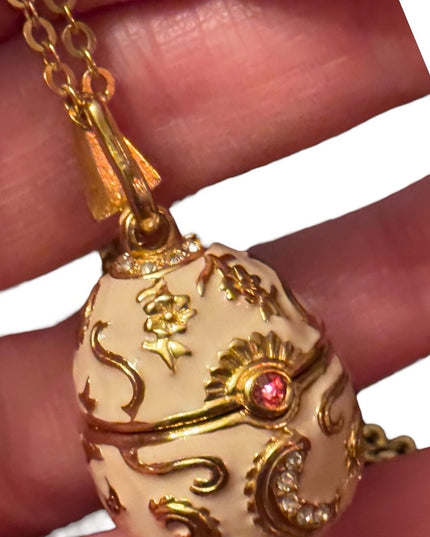 Gold finish creamy enameld crystal embellished Faberge style egg locket necklace