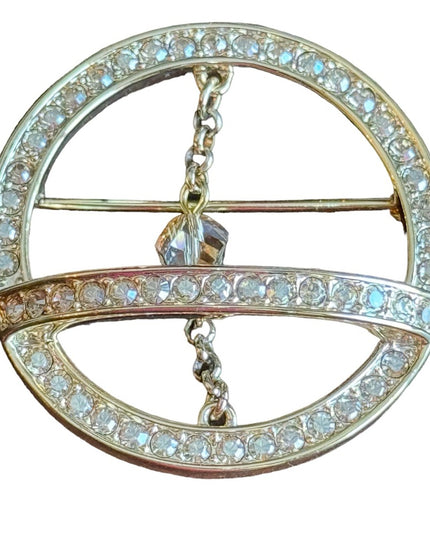 Swarovski gold circle brooch a pave of clear crystal and features a small chain