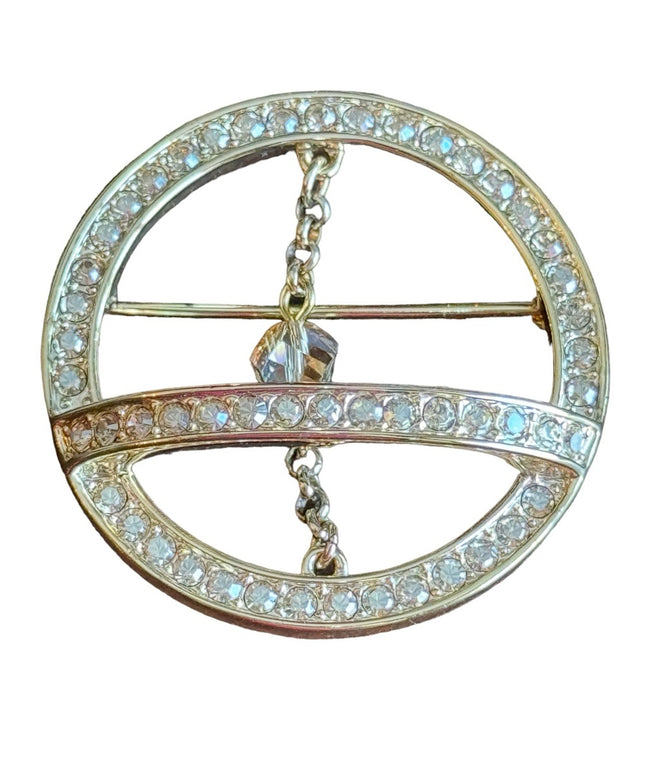 Swarovski gold circle brooch a pave of clear crystal and features a small chain