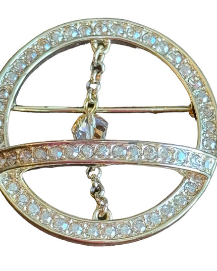 Swarovski gold circle brooch a pave of clear crystal and features a small chain