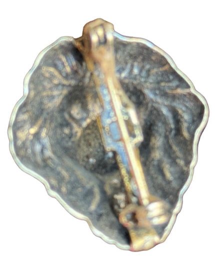 Vintage small brassy lions head brooch
