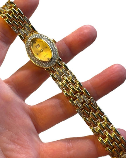 #8 Elizabeth Arden oval face gold tone watch rhinestones TICKING 7”