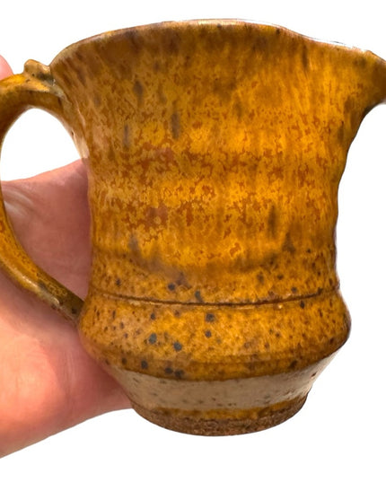Vintage orange glazed handmade pottery creamer cup