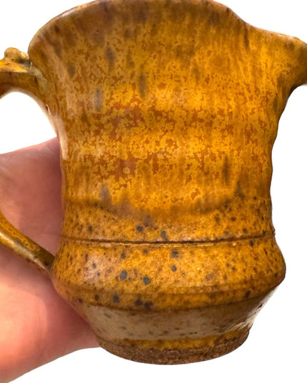 Vintage orange glazed handmade pottery creamer cup