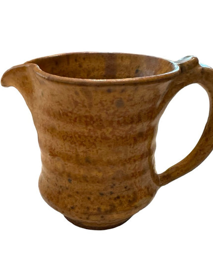 Vintage orange glazed handmade pottery creamer cup