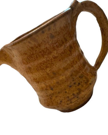 Vintage orange glazed handmade pottery creamer cup