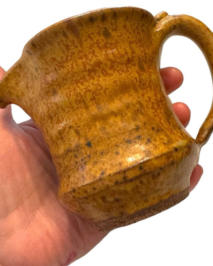 Vintage orange glazed handmade pottery creamer cup